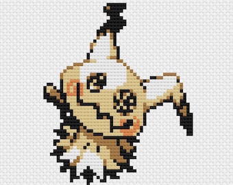 May include: Pixelated cross-stitch design of a Mimikyu character. The character is primarily beige, with black and brown accents. It has a jagged, ghost-like appearance with a small, orange mouth and two black eyes. The background is white.