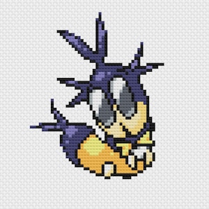 Puede incluir: Imagen pixelada de un personaje de dibujos animados en tonos morados, amarillos y grises. La criatura tiene elementos puntiagudos, ojos grandes y una sonrisa dentuda. El diseño recuerda al punto de cruz o al pixel art.