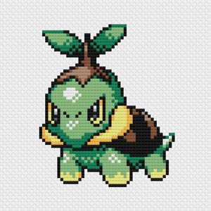 May include: A pixelated cross-stitch design of a green turtle-like creature with a brown shell and two leaf-like structures on its head. The creature has yellow accents and is set against a white background.