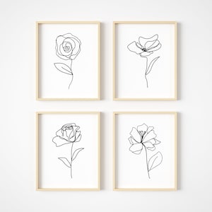 May include: Set of four minimalist line art prints featuring black and white floral illustrations. Each print depicts a single flower with a simple stem and leaves.