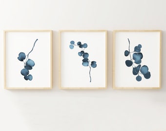May include: Three framed prints with a watercolor style design of blue eucalyptus branches on a white background.
