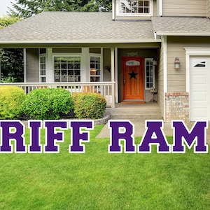 May include: A purple and white "RIFF RAM" yard sign in front of a house with a brown door and a white garage door.