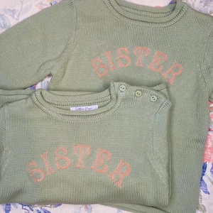 シスター刺繍ロールネックセーター