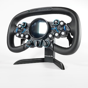 May include: A black racing wheel with a carbon fiber design, a central screen, and multiple buttons. The wheel is mounted on a black stand with the brand name "MOZA" visible.