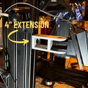 May include: A 4" extension for a 3D printer, printed in white plastic. The extension is attached to a black metal frame.