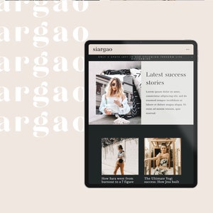 May include: A black tablet displays a website with the text "siargao" and "Latest success stories." The website features images and text, including "How Sara went from burnout to a 7 figure" and "The Ultimate Yogi success: How Jess built."
