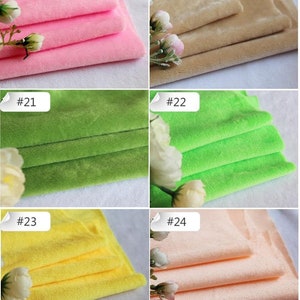 May include: A close-up of ten fabric swatches in different colors. The swatches are folded in thirds and arranged in two rows of five. The colors are pink, beige, green, lime green, yellow, and peach.