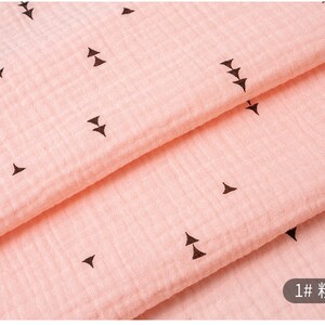 May include: Pink fabric with a repeating pattern of small black triangles. The fabric is folded in half and the text "1# 粉红" is visible in the bottom right corner.