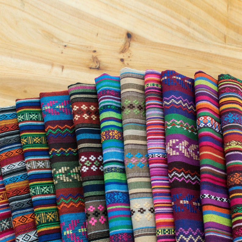 May include: A collection of colorful fabric swatches with geometric patterns. The fabrics are arranged in a row, with the most colorful fabric at the top and the least colorful fabric at the bottom.