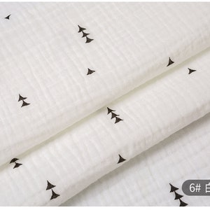 May include: White fabric with a subtle texture and a repeating pattern of small black triangles. The fabric is folded in half, and the text "6# 白色" is visible in the lower right corner.