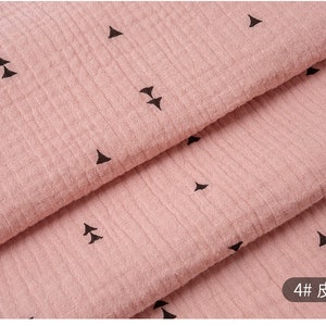 May include: Pink fabric with a black triangle pattern. The fabric is folded in thirds, showing the pattern on each layer. The text "4# 皮红" is visible in the bottom right corner of the image.