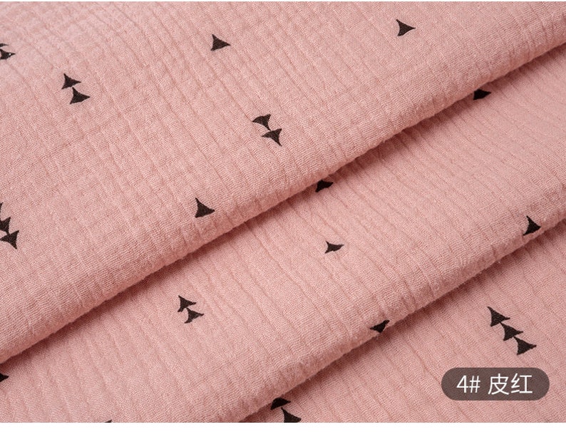 May include: Pink fabric with a black triangle pattern. The fabric is folded in thirds, showing the pattern on each layer. The text "4# 皮红" is visible in the bottom right corner of the image.