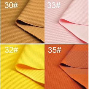 May include: A close-up of eight different colors of ribbed fabric swatches. The swatches are labeled with numbers 29 through 36.