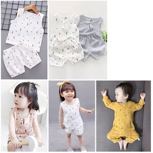 May include: A set of three baby outfits with geometric patterns. The first outfit is white with black triangles, the second is white with black triangles and a ruffle, and the third is yellow with black dots.
