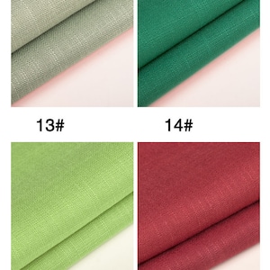 May include: Four fabric swatches in different colors: light green, dark green, light green, and burgundy red. The swatches are folded in half and the fabric has a textured weave.