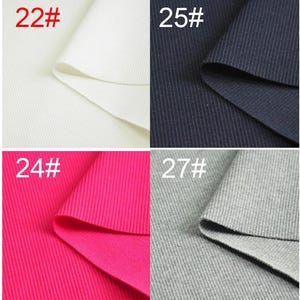 May include: Eight fabric swatches in different colors, including gray, white, black, beige, pink, and red. Each swatch is labeled with a number from 21 to 28.