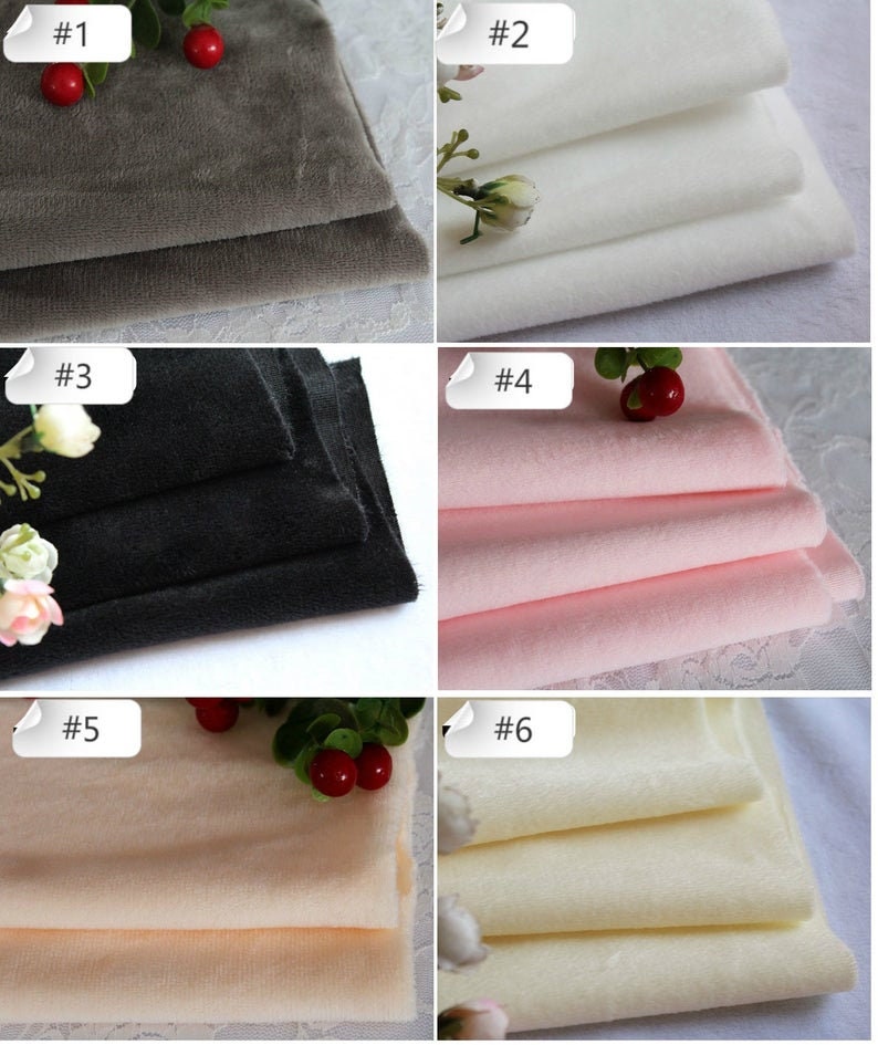May include: Six fabric swatches in different colors, including gray, white, black, pink, beige, and cream. The swatches are folded and arranged in a grid pattern. Each swatch is labeled with a number from 1 to 6.