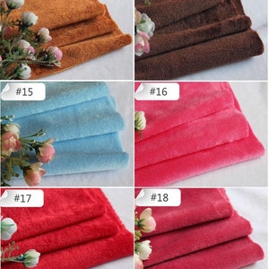 May include: Close-up of six fabric swatches in different colors. The swatches are folded in thirds and arranged in two rows of three. The colors are brown, dark brown, light blue, pink, red, and burgundy.