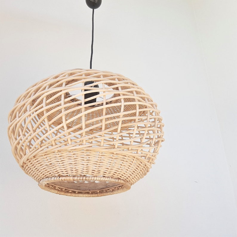 May include: A round, woven wicker pendant light fixture with a black cord.