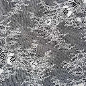 May include: White lace fabric with a delicate floral pattern. The lace has a fine mesh texture and features intricate details.
