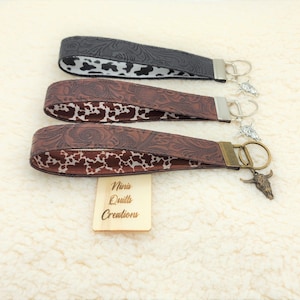 Western vegan black or brown, embossed Faux leather key fob wristlet, keychain, lined with cowhide print, bull skull charm, hands free.