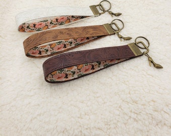 Floral western tooled vegan faux leather key fob wristlet, lined with neutral boho floral, hands free, easy to find in bag.