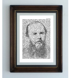 May include: A black and white image of a man's face created using text from a book. The text is in Russian and the image is framed in a dark wood frame.