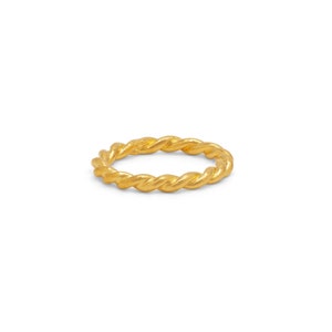 May include: A gold-colored twisted ring. The ring is made of a thick, rope-like material.