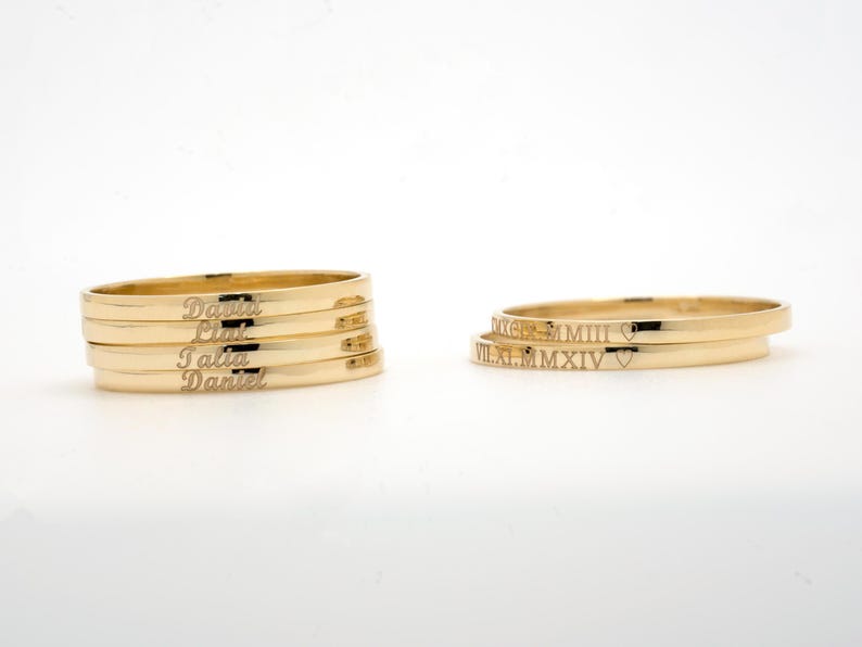 May include: Four gold rings with the names "Daniel", "Lily", "Talia", and "Daniel" engraved on them. Two gold rings with Roman numerals "VIII.XI.M.MMXIV" and a heart symbol engraved on them.