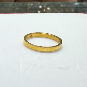 Puede incluir: Un anillo de banda de oro simple con un acabado liso. El anillo tiene una peque&ntilde;a inscripci&oacute;n en el interior que dice "9K".