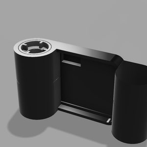 May include: A black film camera with two spools for film. The camera has a rectangular viewfinder and a small button on the side.