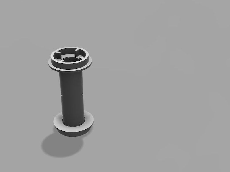 May include: A gray plastic spool with a center hole and a raised ring on each end.