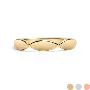 May include: A gold ring with a repeating oval design. The ring is made of polished gold and has a smooth, reflective surface. The design consists of three connected oval shapes.