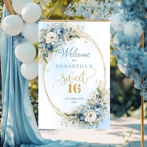 May include: A sign with the text "Welcome to Samantha's Sweet 16" in gold script, surrounded by a floral wreath of blue and white flowers. The sign is framed with a gold border and includes the date October 25th, 2031.