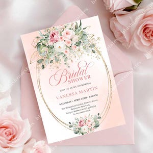 May include: A blush pink bridal shower invitation with floral accents. The invitation features a gold oval frame, the words "Bridal Shower", and event details. The invitation is placed inside a pink envelope, with roses in the background.