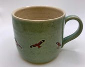 Hand thrown stoneware mug decorated with red kite birds.  A unique item.