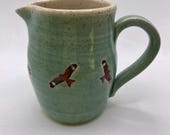 Hand thrown ceramic milk jug, decorated with red kite birds.  A unique item.