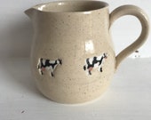 A hand made milk jug decorated with cows. A charming and unique gift.