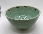 Stoneware bowl decorated with red kite birds.  A unique item.