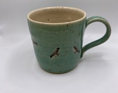 Hand thrown stoneware mug decorated with red kite birds.  A unique and charming gift.