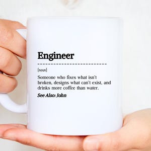 May include: White ceramic mug featuring the word "Engineer" in black, accompanied by a definition. The definition states: "Someone who fixes what isn't broken, designs what can't exist, and drinks more coffee than water."