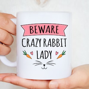 Woman holding beware crazy rabbit lady mug