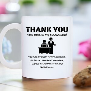 May include: White ceramic coffee mug with black text that reads "Thank you for being my manager!" and a cartoon image of a manager and employee. The text continues, "You are the best manager ever. If I had a different manager, I would have had a nervous breakdown."