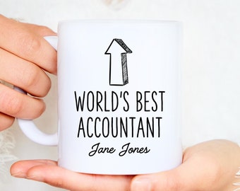 May include: White ceramic mug with black text that reads "World's Best Accountant Jane Jones" and a black and white arrow pointing upwards.