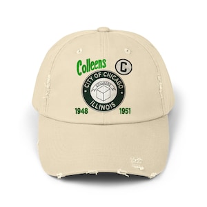 May include: A beige distressed baseball cap with a green and white logo that says "Colleens City of Chicago 1948 Illinois 1951" and a green "C" above the logo.