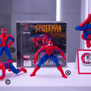 May include: A display of Spider-Man figurines in dynamic poses, featuring red and blue suits. A PlayStation game case with the Spider-Man title is visible. A sign with Japanese text and the word "FIGURES" is also present.