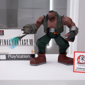 May include: A papercraft figure of Barret from Final Fantasy VII stands next to a PlayStation game box. The figure is brown, green, and gray, with a determined pose. The game box features the Final Fantasy VII logo and PlayStation branding.