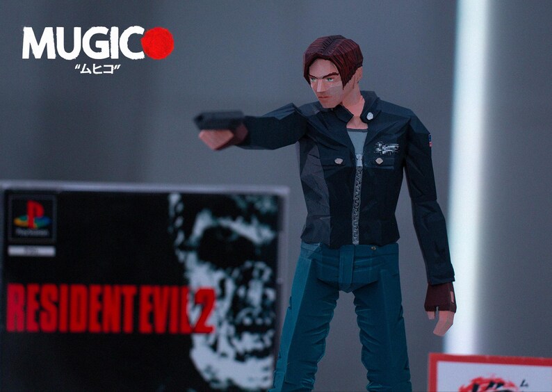 May include: A black and blue action figure of a man holding a gun. The figure is wearing a black jacket, blue jeans, and a black shirt. The figure is standing in front of a video game case with the text "RESIDENT EVIL 2" on it.