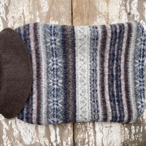 May include: A brown and white striped dog sweater with a brown collar. The sweater is made of a soft, fuzzy material.