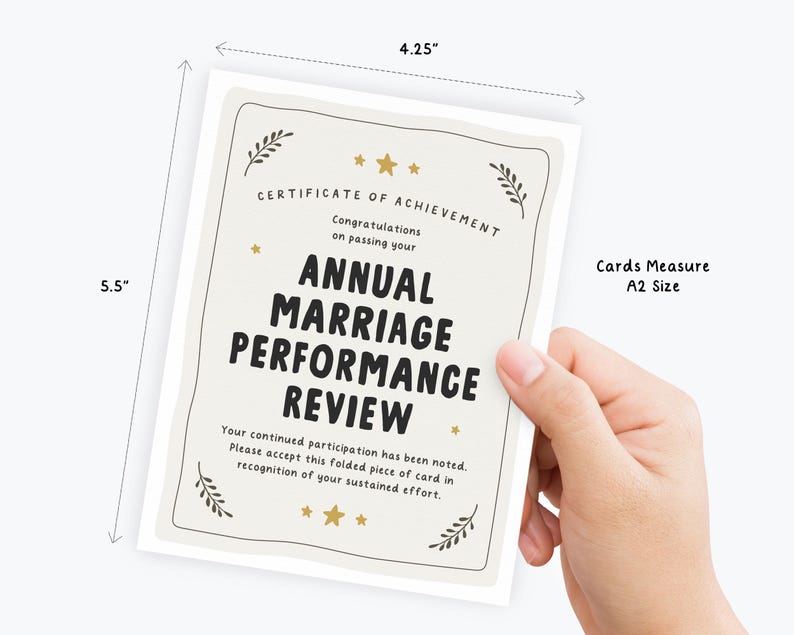 May include: A white A2 size greeting card measuring 4.25 inches by 5.5 inches. The card features black text reading Certificate of Achievement, Congratulations on passing your Annual Marriage Performance Review, and additional text, with gold stars and leaf accents.